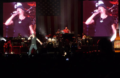 Kid Rock, flanked by giant video shots of himself, sings Friday night at the Cruzan. (Photo by Thom Smith)