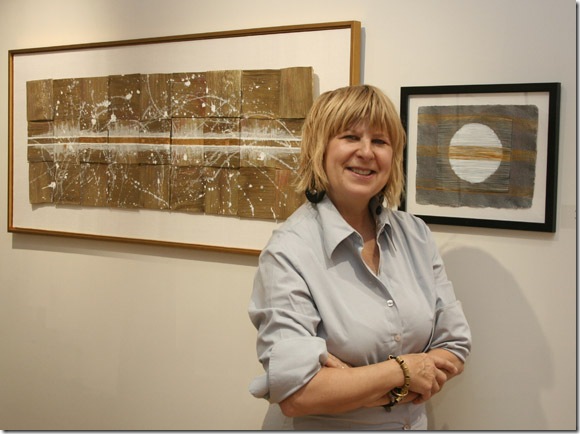 Bosha Stone with her paintings on palm leaves. (Photo by Katie Deits) 