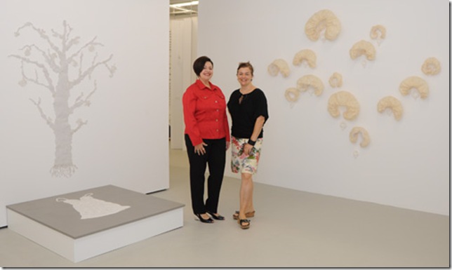 Elayne Mordes and Kara Walker-Tomé in the “Beyond Delicate” exhibition at the WhiteSpace Collection. Artwork on the left is by Giannina Coppiano Dwin and on the right is by Carolyn Sickles. (Photo by Katie Deits)