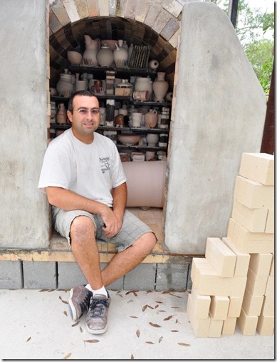 Justin Lambert in front of his kiln at Live Oak Pottery.