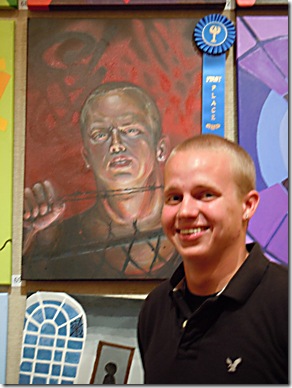 Nicholas Cordes, in front of an untitled painting of his that won first place. (Photo by Katie Deits)
