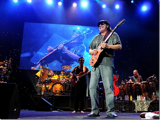 Carlos Santana and the band. (Photo by Tom Craig/Live Nation)