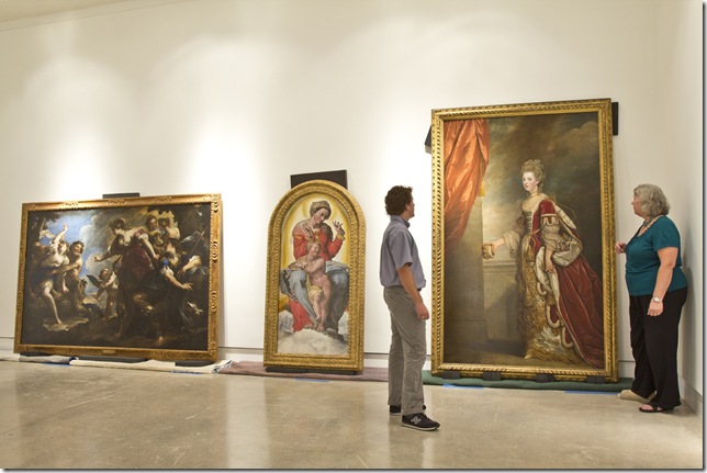 John Welter, Norton Museum of Art assistant registrar, and Pam Parry, registrar, prepare some Old Masters for reinstallation. From left: Diana and Actaeon with Pan and Syrinx (1650-55) by Valerio Castello; Madonna and Child in Glory, by Giovanni Bezzi (1560s); and Jane, Duchess of Gordon (1775-78), by Sir Joshua Reynolds. (Photo by Kelli Marin) 