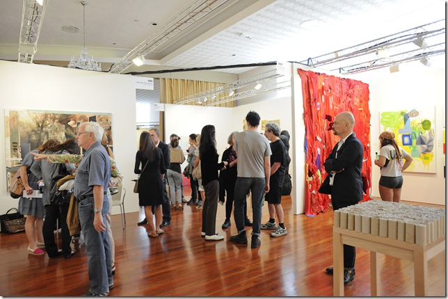 Patrons view the art at the NADA fair in Miami Beach. (Photo by Casey Kelbaugh)