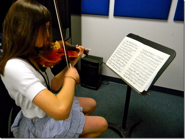 Elisabeth Schreiber, 11, of Lake Worth, practices her violin. (Photo by Chloe Elder)