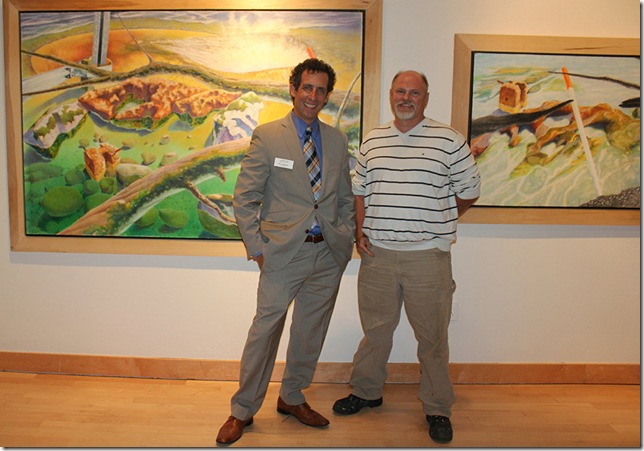 Boca Raton Museum of Art curator Stephen Maklansky (left) and artist Geoff Hamel stand in front of two works by Hamel.