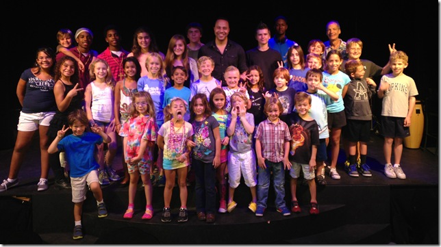 Drew Tucker (center) with the kids of the Arts Garage Performing Arts Academy Summer Camp, cutting up.