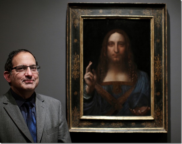 Robert Simon stands next to Salvator Mundi, by Leonardo da Vinci.