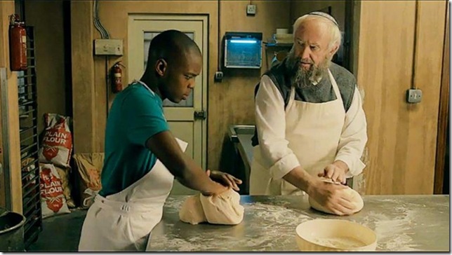 Jerome Holder and Jonathan Pryce in “Dough.”