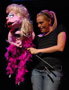 Nicole Piro operates Lucy T. Slut in Slow Burn Theatre's Avenue  Q.